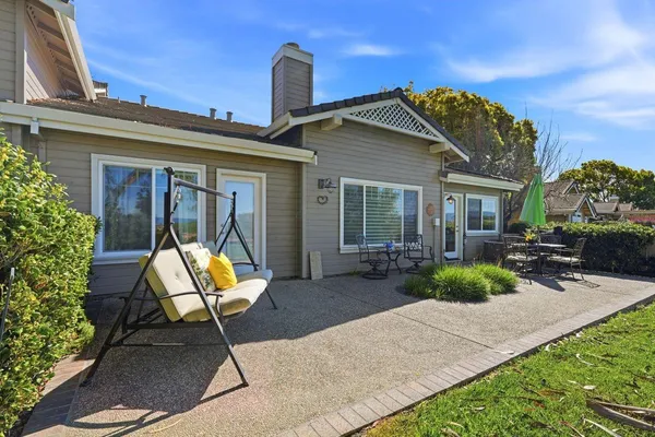 a view of a house with backyard sitting area and garden