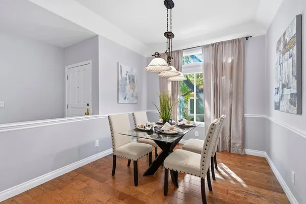 a view of a dining room with furniture window and wooden floor
