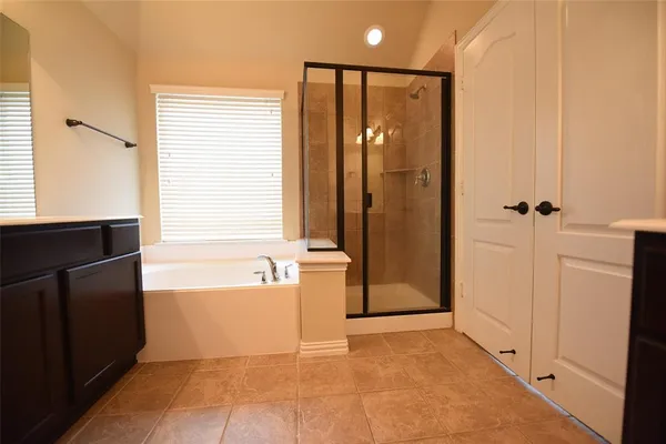 a bathroom with a bathtub and a shower