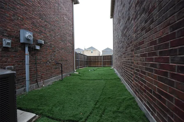 a view of a backyard with brick wall