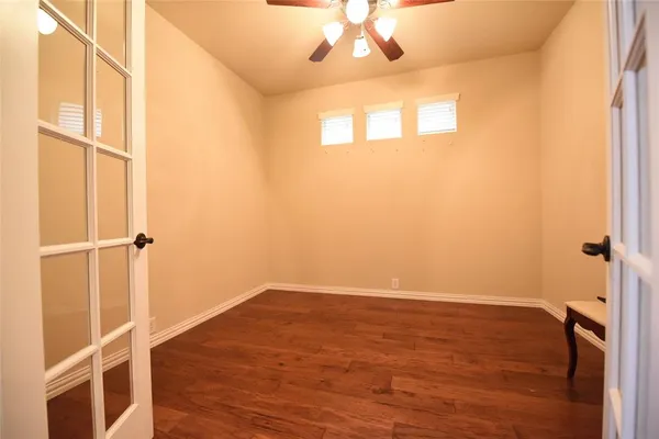 a view of a room with wooden floor and a window
