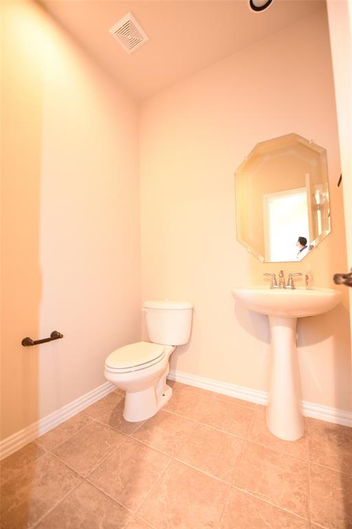 855 Llano Drive Allen, TX 75013 - Photo 9 of 20 a bathroom with a toilet sink and mirror