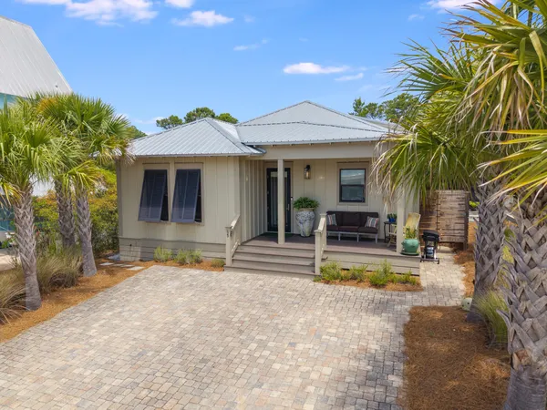a view of a house with swimming pool and sitting area