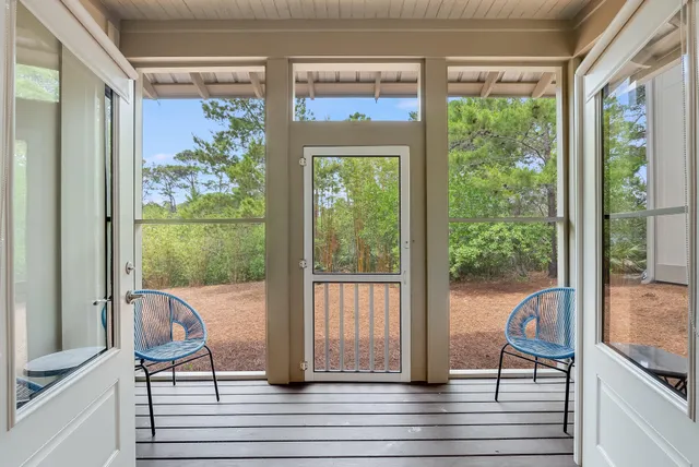 a view of a balcony with chair and front door