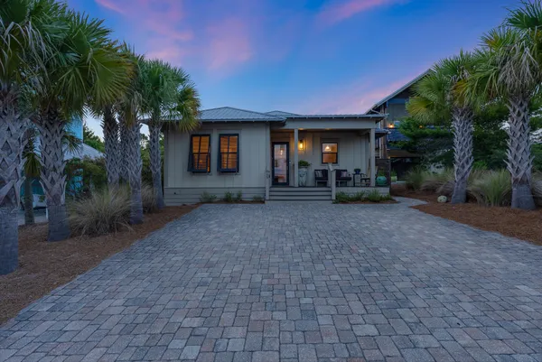 a view of a house with a yard and tree s