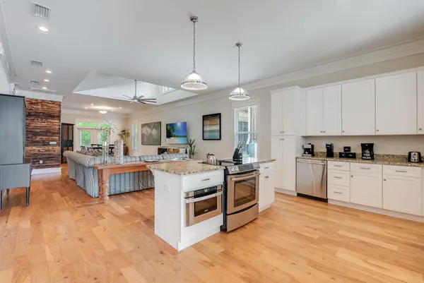 a kitchen with stainless steel appliances granite countertop a stove oven and a refrigerator