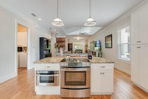a kitchen with a stove and a wooden floor