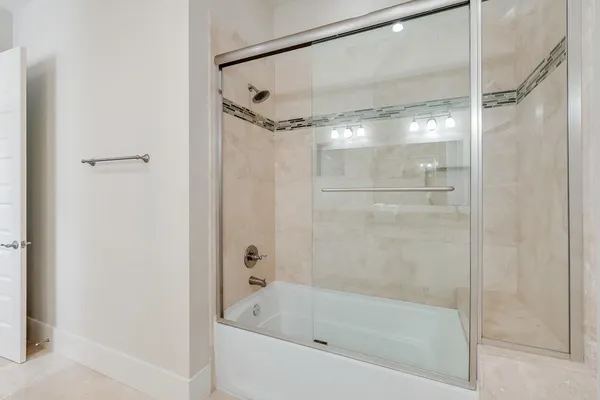 a bathroom with a bathtub and a shower
