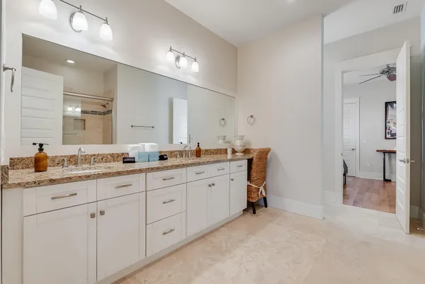 a spacious bathroom with a granite countertop sink mirror and double