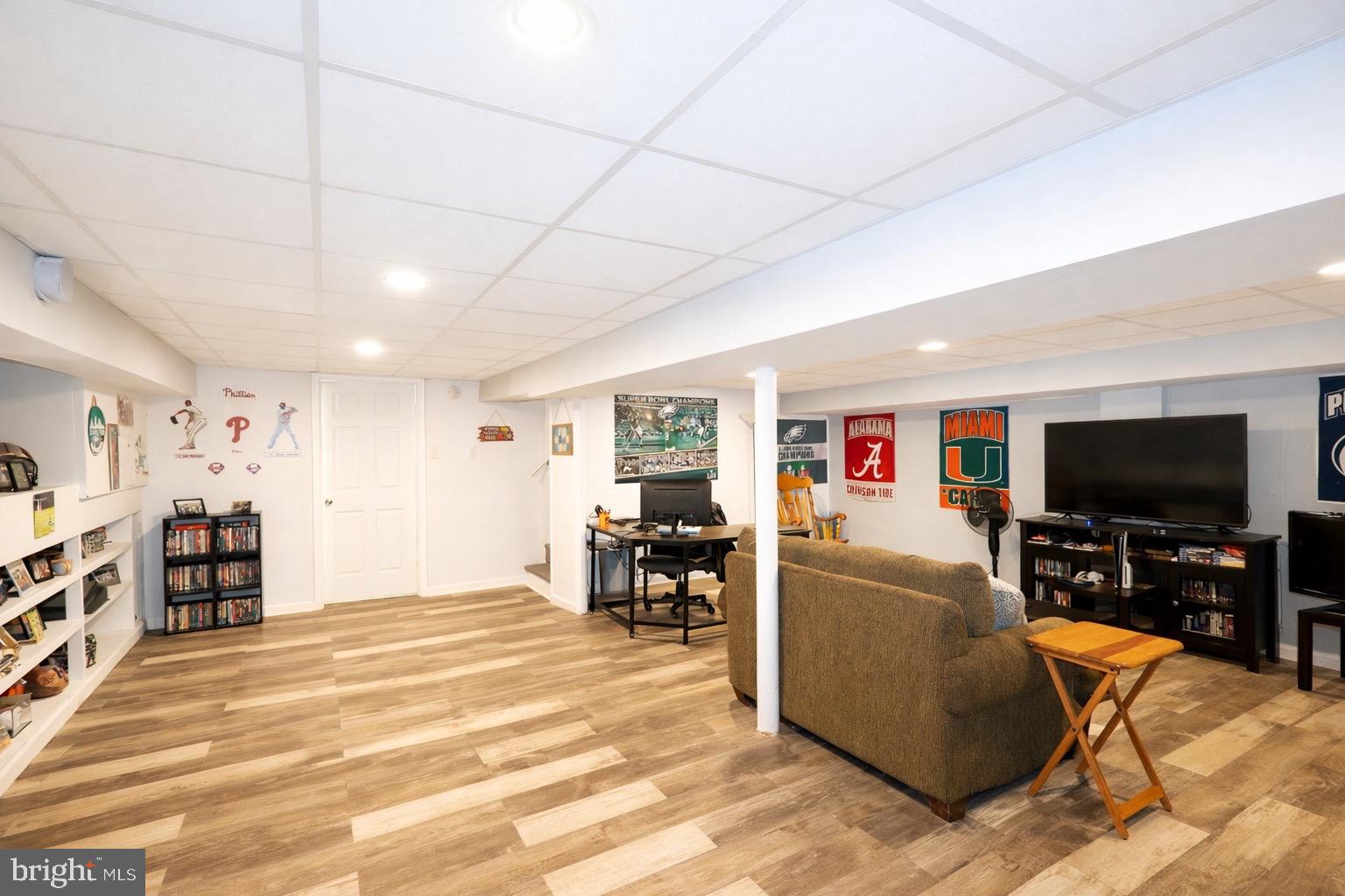 418 Perkins Lane Delanco, NJ 08075 - Photo 13 of 17 Spacious basement with sports-themed decor.