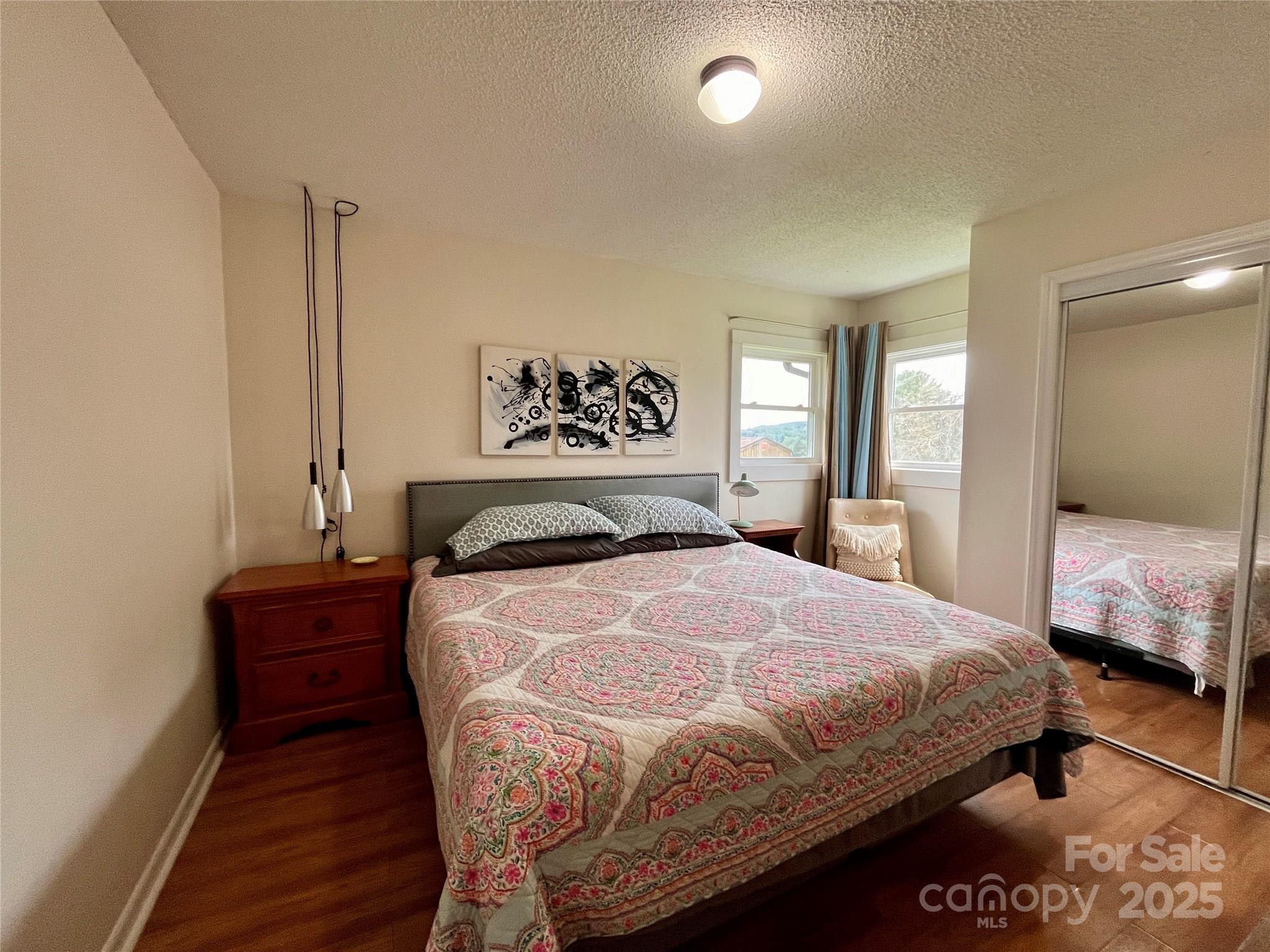 657 Arrowhead Trail Marion, NC 28752 - Photo 11 of 22 a bedroom with a bed and wooden floor