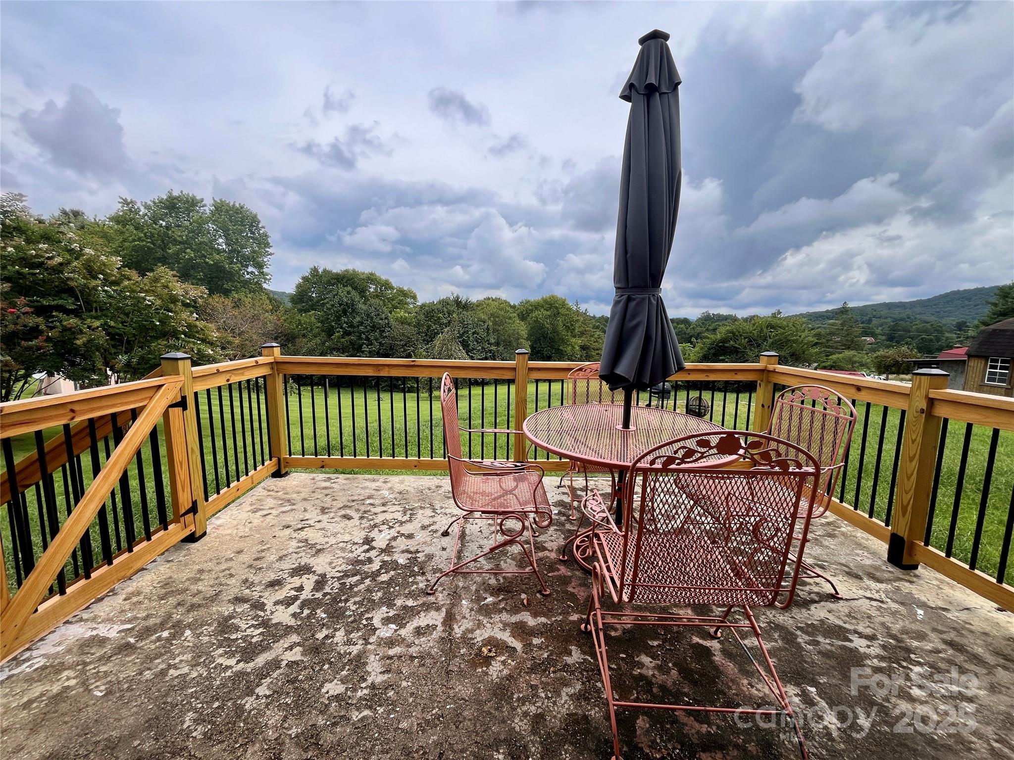 657 Arrowhead Trail Marion, NC 28752 - Photo 7 of 22 a view of a chairs and table on wooden deck