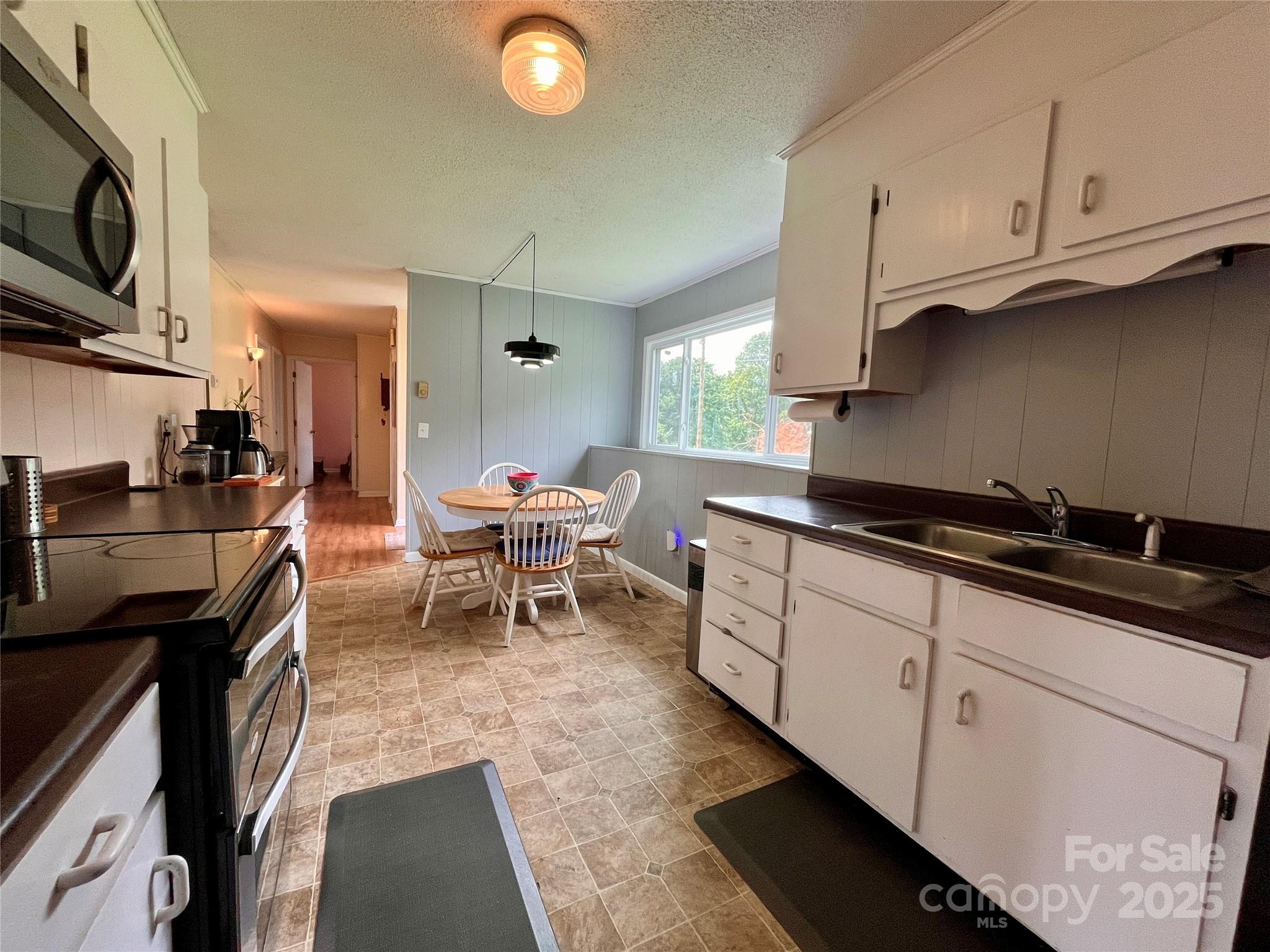 657 Arrowhead Trail Marion, NC 28752 - Photo 10 of 22 a kitchen with stainless steel appliances granite countertop a sink and a stove