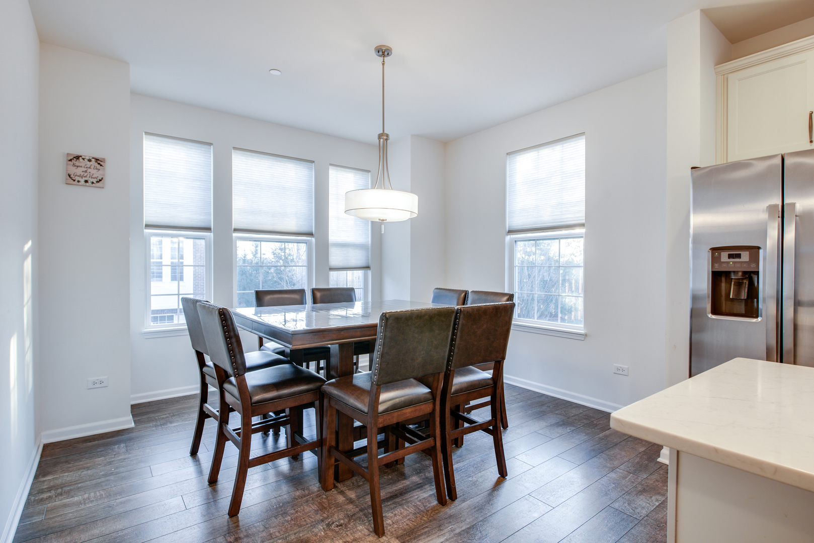 4477 Monroe Court Naperville, IL 60564 - Photo 10 of 23 a view of a dining room with furniture window and wooden floor