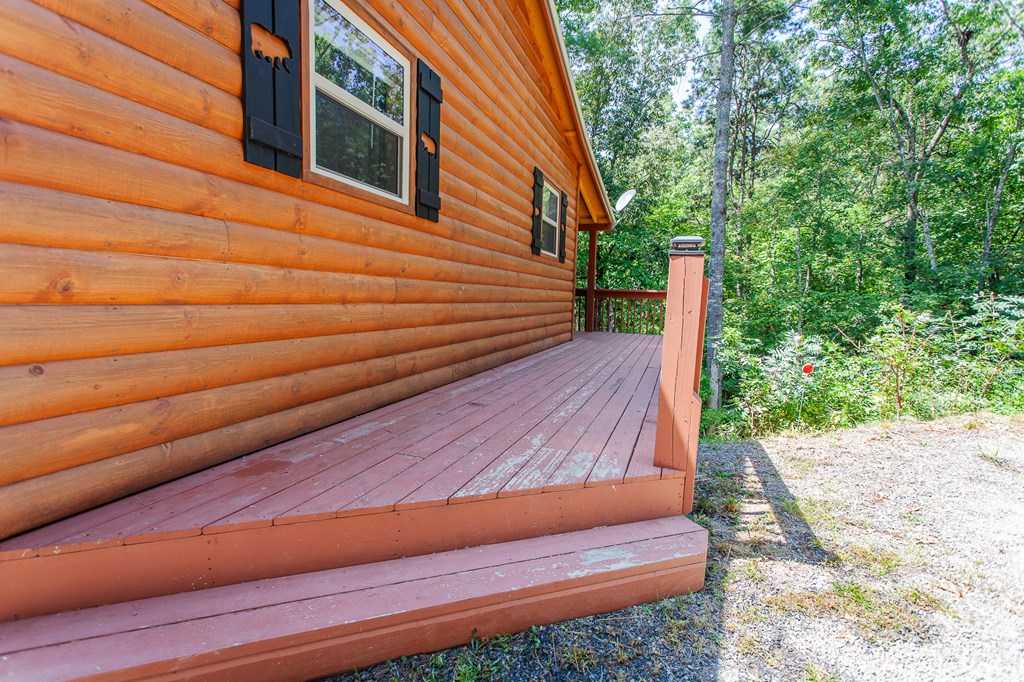 15 Fern Rdg Trail Murphy, NC 28906 - Photo 32 of 40 a backyard of a house with wooden floor and fence and trees