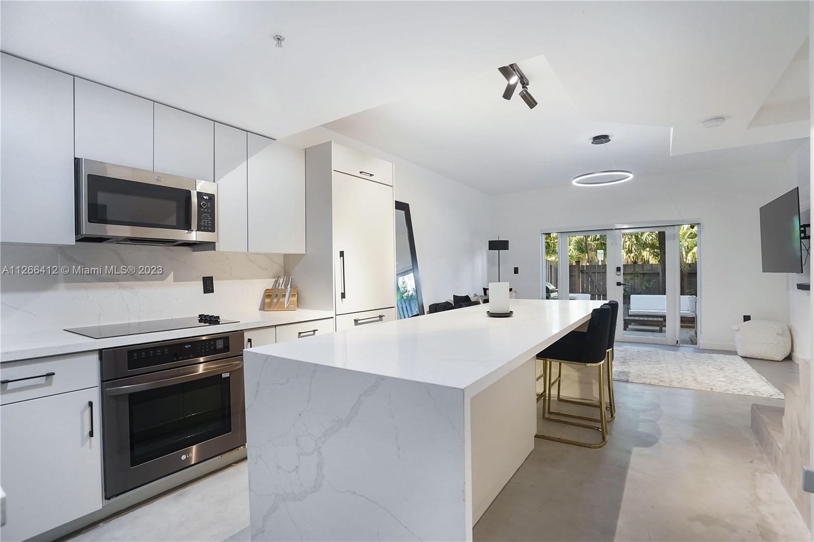 123 Southwest 17th Road, Unit 104 Miami, FL 33129 - Photo 1 of 34 a kitchen with a sink stove and microwave