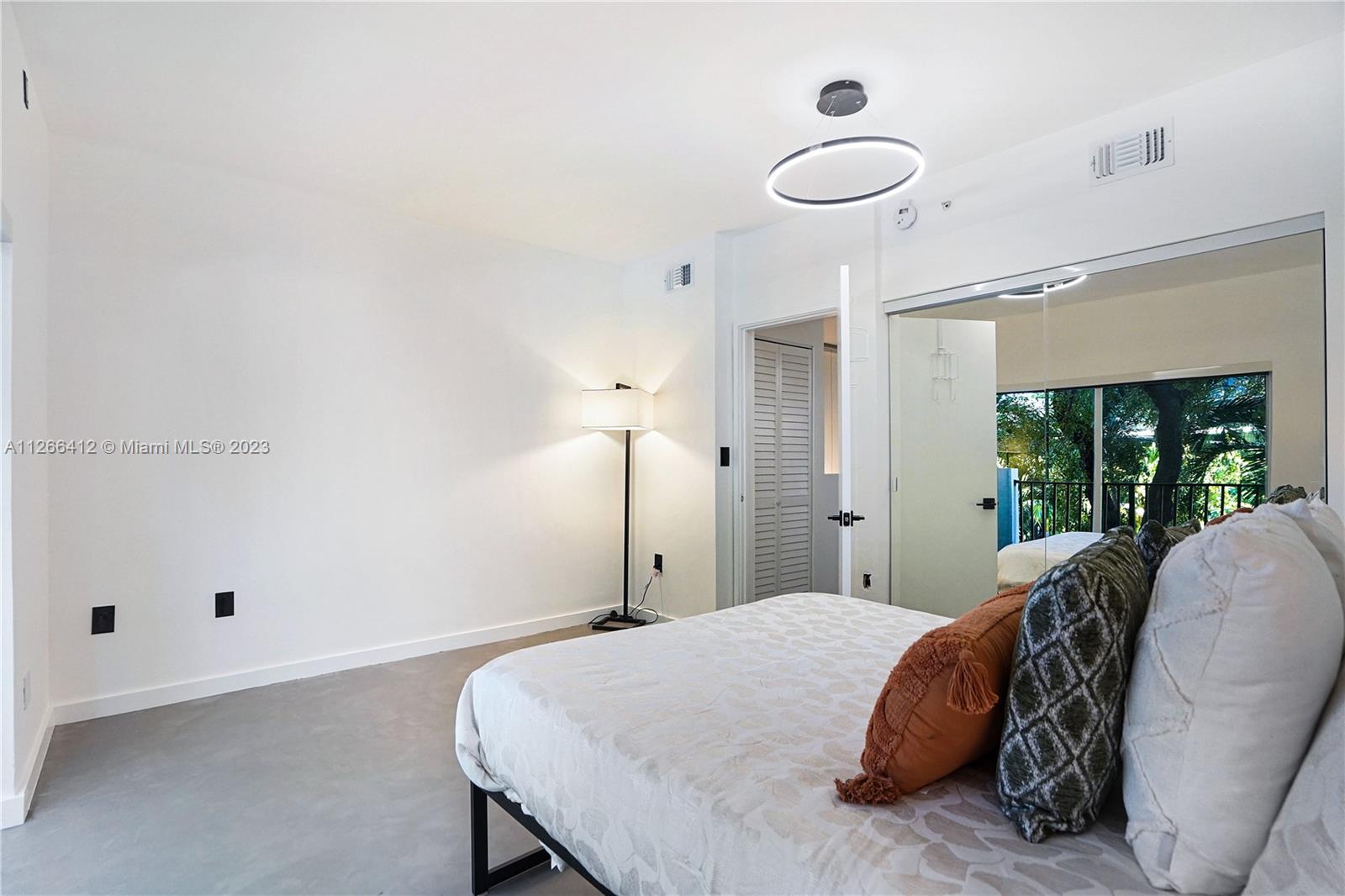 123 Southwest 17th Road, Unit 104 Miami, FL 33129 - Photo 12 of 34 a spacious bedroom with a bed and a window