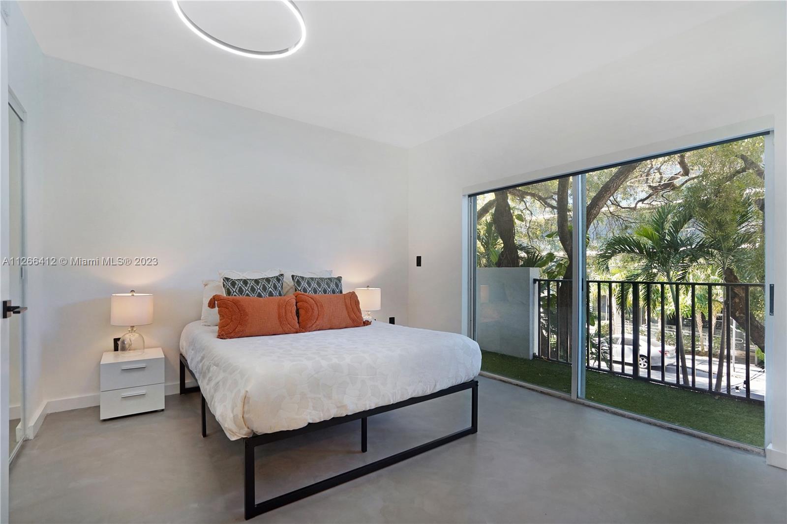 123 Southwest 17th Road, Unit 104 Miami, FL 33129 - Photo 13 of 34 a bedroom with a bed and a large window