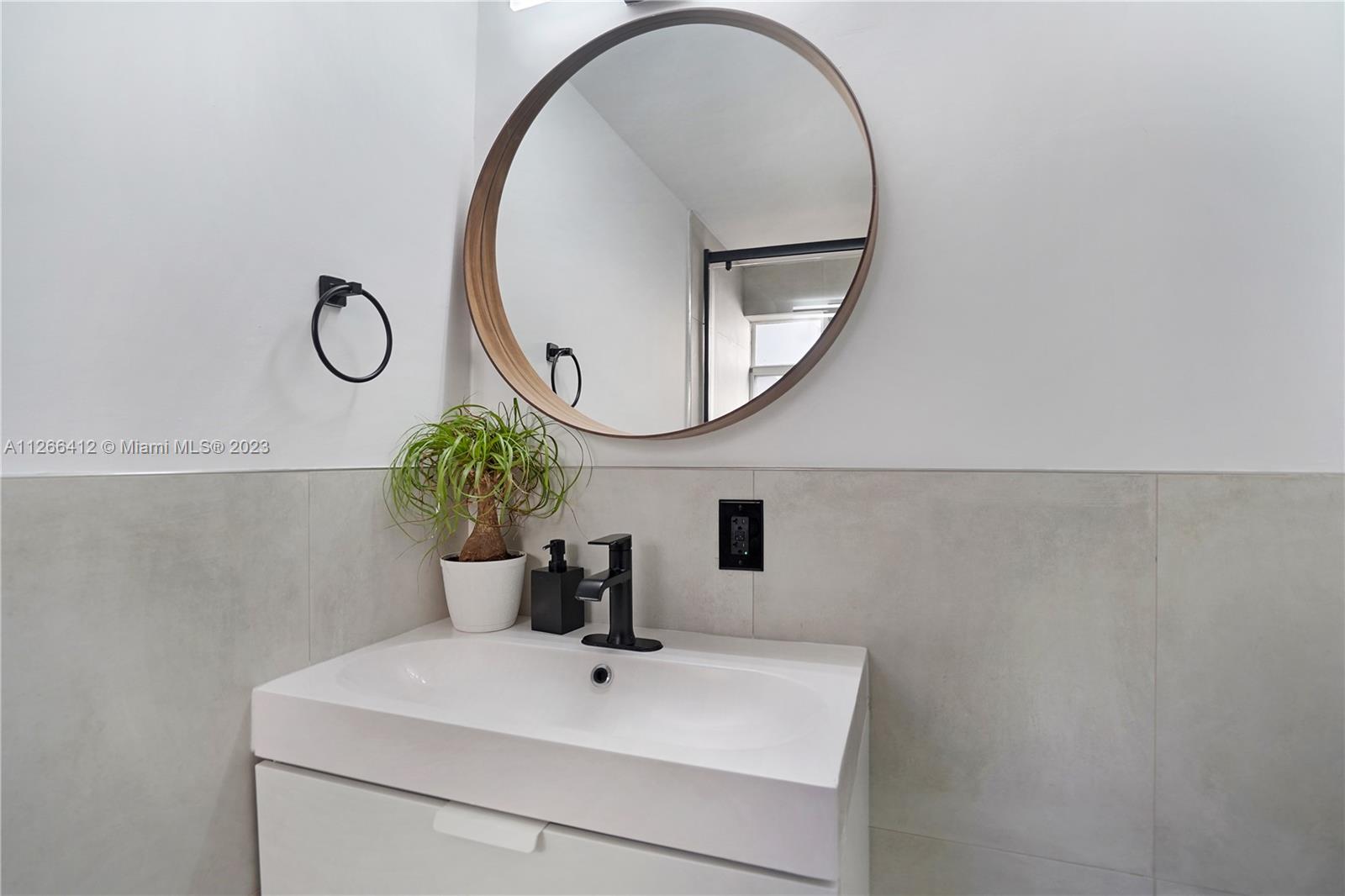 123 Southwest 17th Road, Unit 104 Miami, FL 33129 - Photo 15 of 34 a bathroom with a sink and a mirror