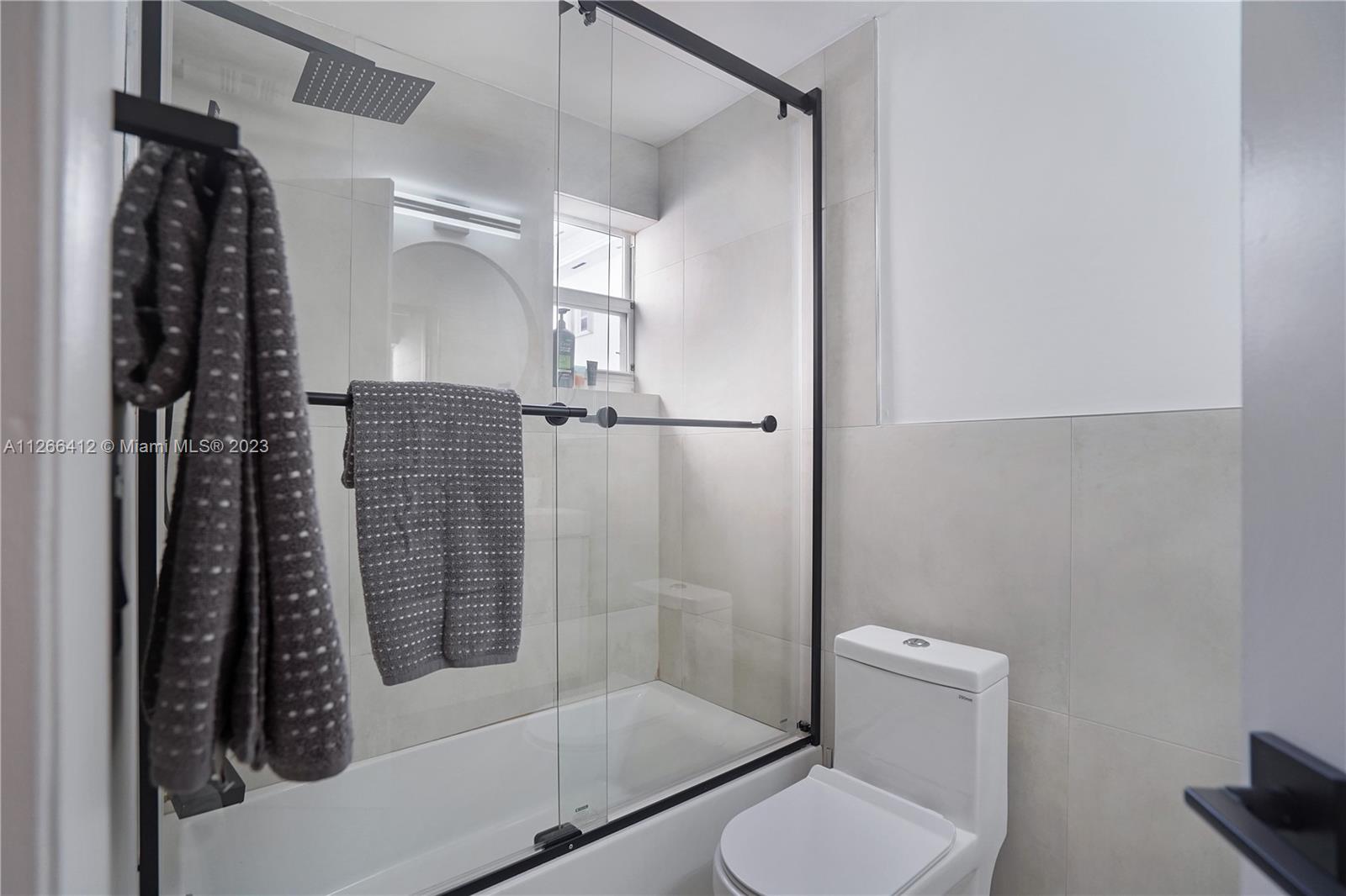 123 Southwest 17th Road, Unit 104 Miami, FL 33129 - Photo 16 of 34 a bathroom with a shower toilet and sink