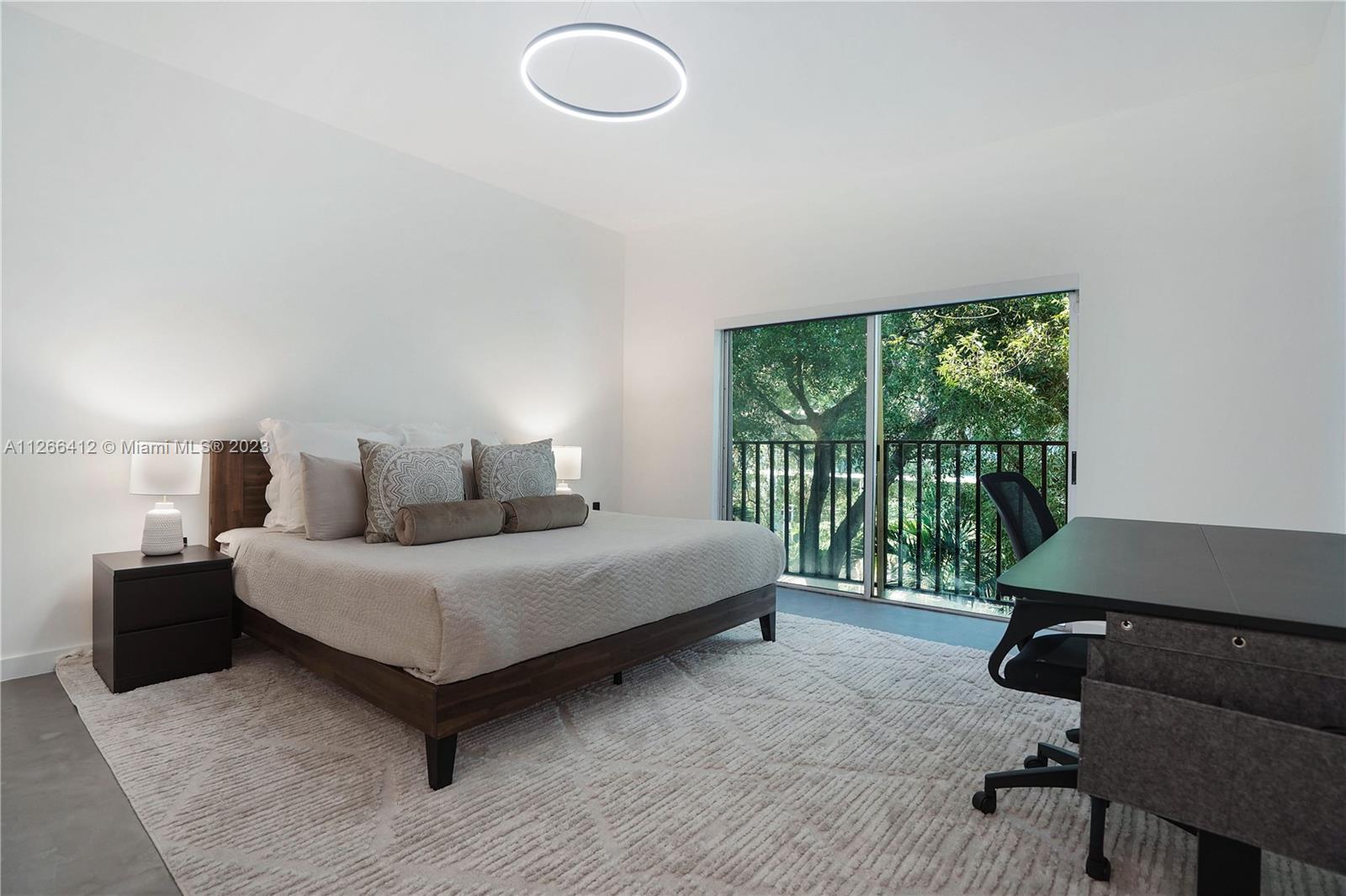 123 Southwest 17th Road, Unit 104 Miami, FL 33129 - Photo 19 of 34 a spacious bedroom with a bed and a window