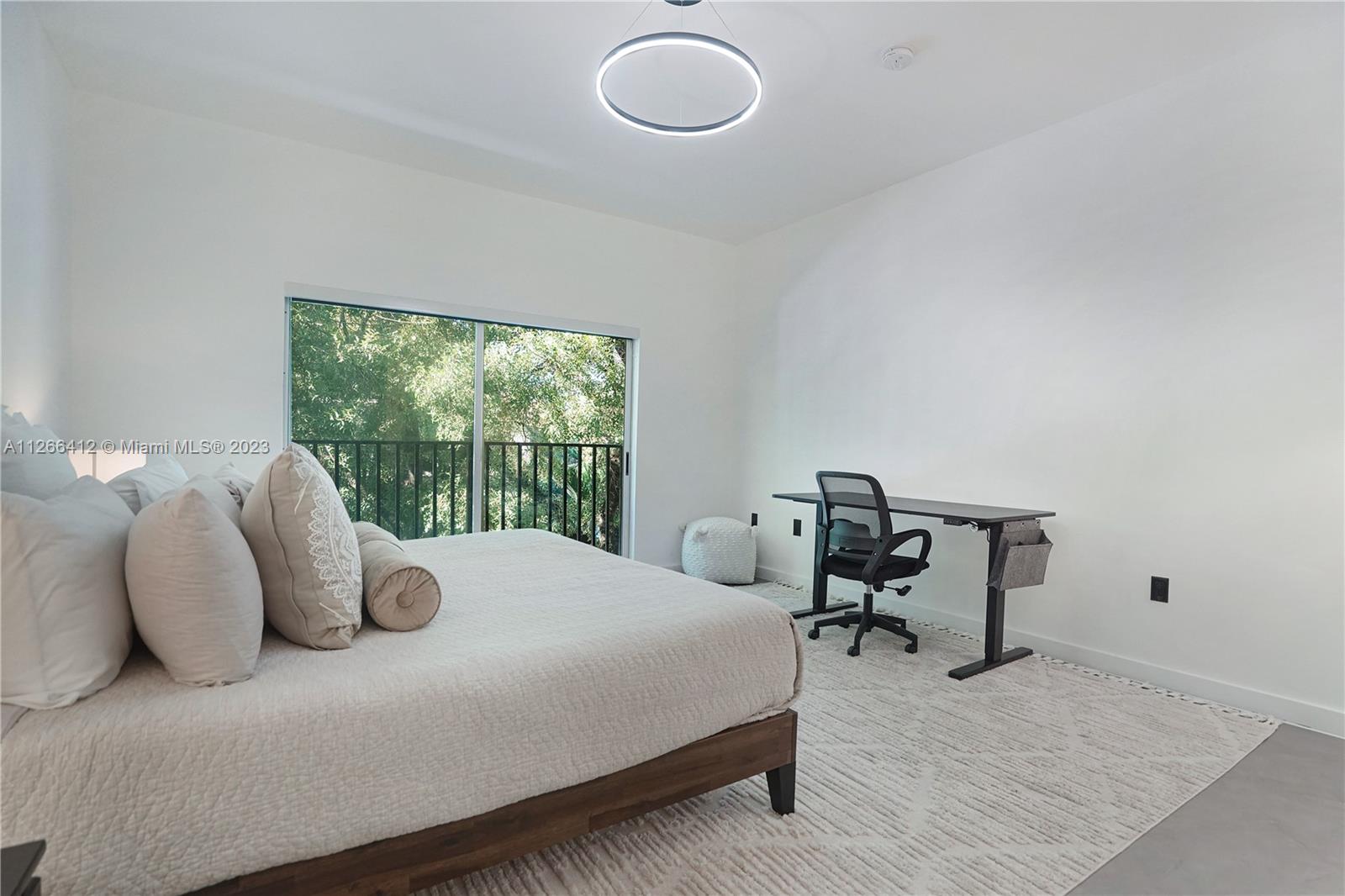 123 Southwest 17th Road, Unit 104 Miami, FL 33129 - Photo 20 of 34 a bedroom with a bed and window