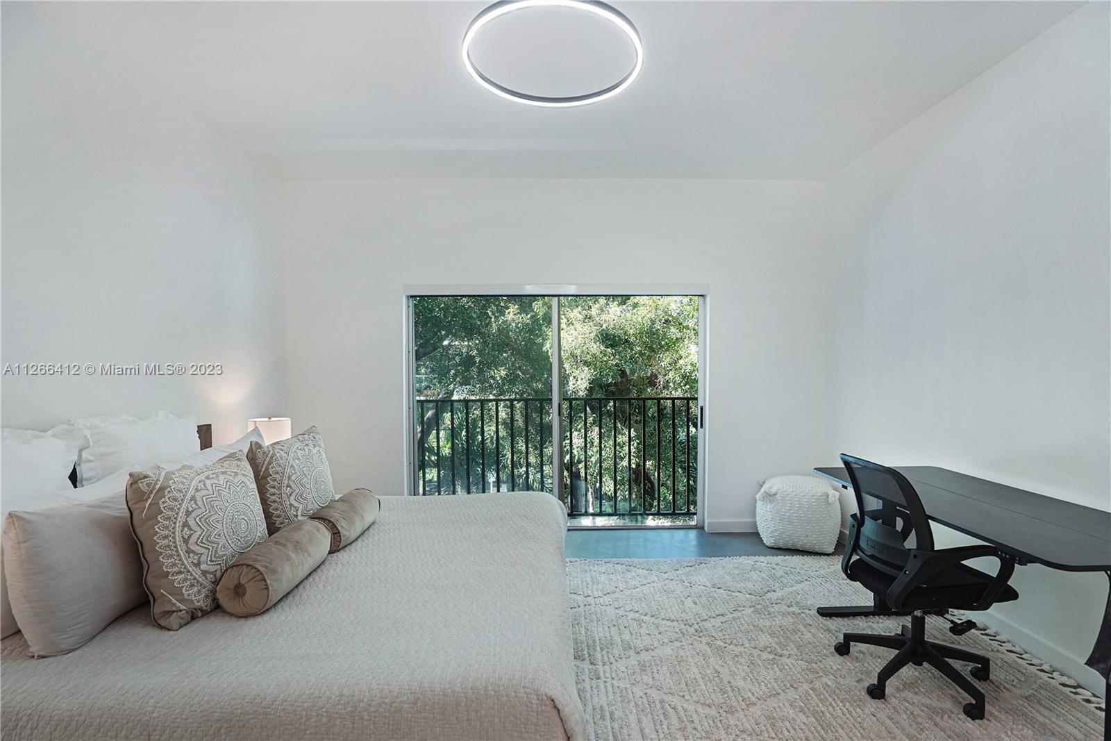 123 Southwest 17th Road, Unit 104 Miami, FL 33129 - Photo 21 of 34 a bed room with a bed and a chair