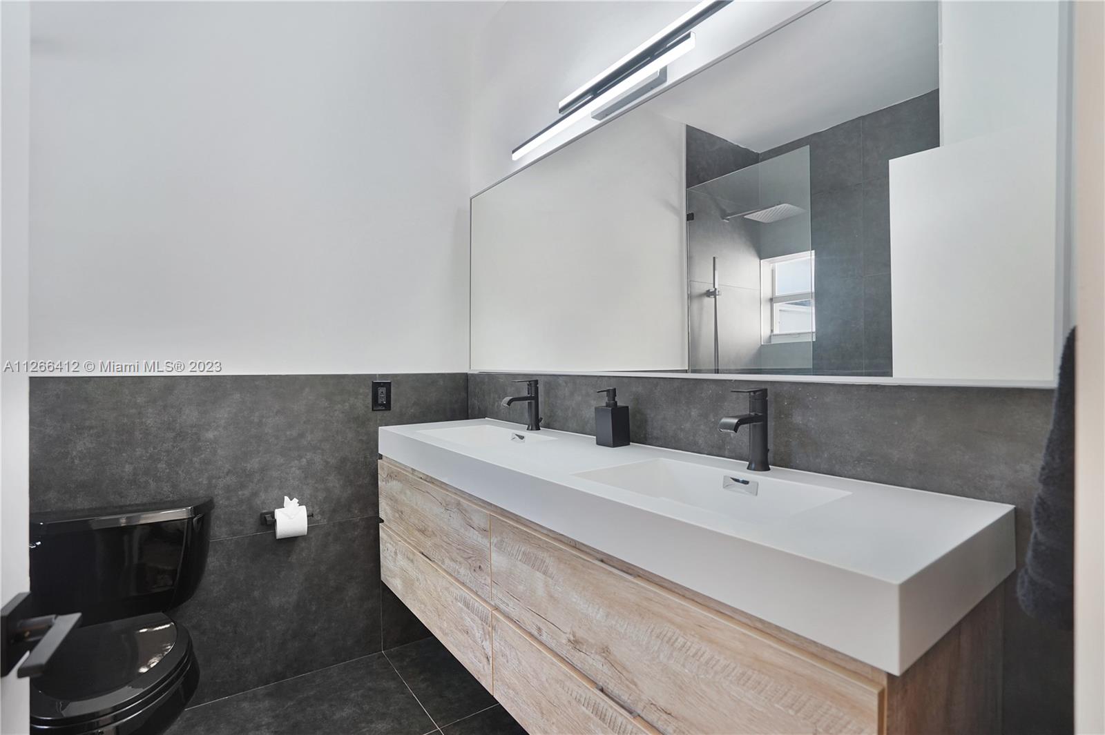 123 Southwest 17th Road, Unit 104 Miami, FL 33129 - Photo 23 of 34 a bathroom with a sink and a mirror