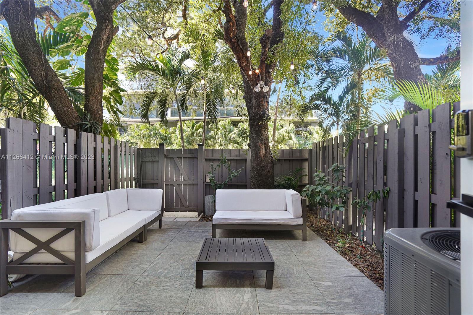 123 Southwest 17th Road, Unit 104 Miami, FL 33129 - Photo 27 of 34 a bench sitting in the middle of a backyard