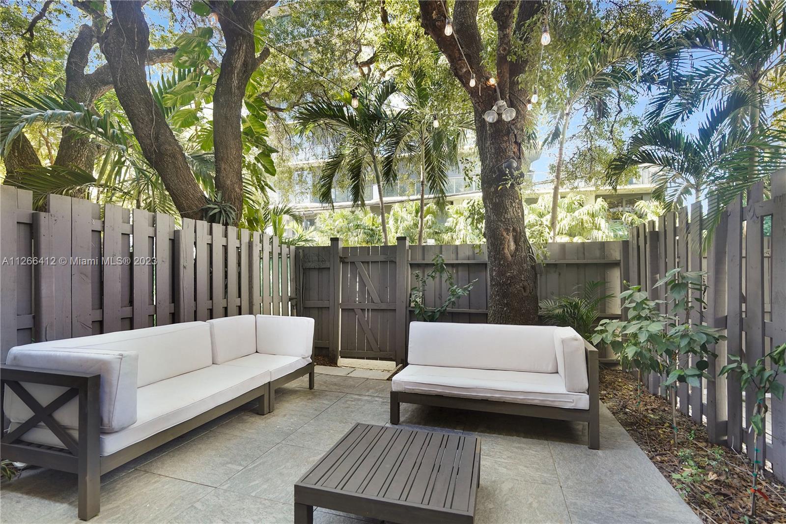123 Southwest 17th Road, Unit 104 Miami, FL 33129 - Photo 28 of 34 a view of sitting area with furniture and trees