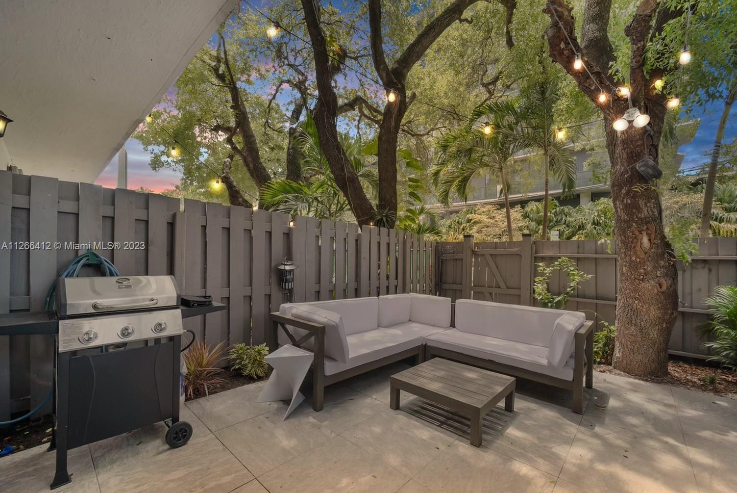 123 Southwest 17th Road, Unit 104 Miami, FL 33129 - Photo 30 of 34 a view of a backyard with couches and a fire pit