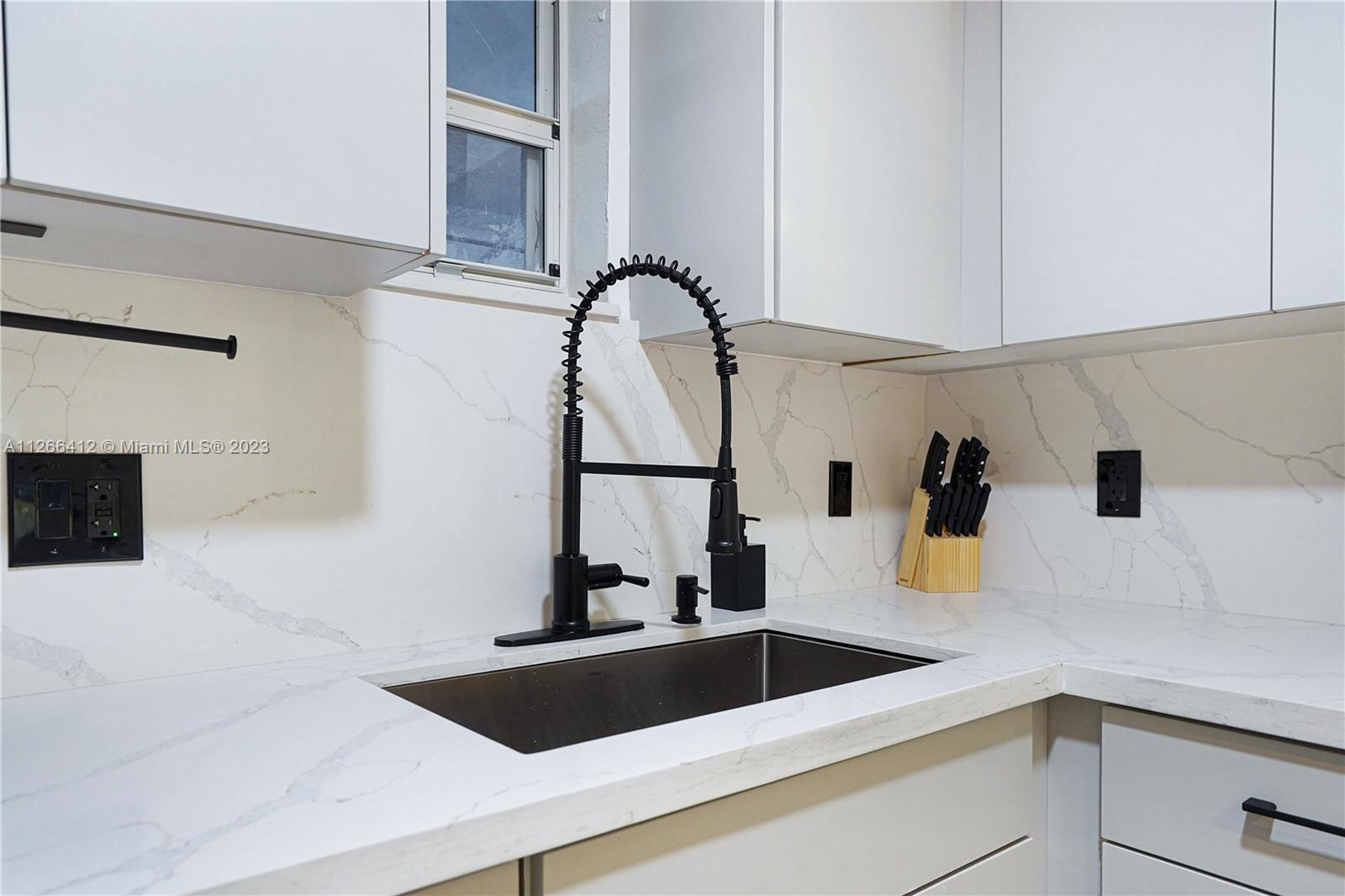 123 Southwest 17th Road, Unit 104 Miami, FL 33129 - Photo 5 of 34 a close view of sink and tap