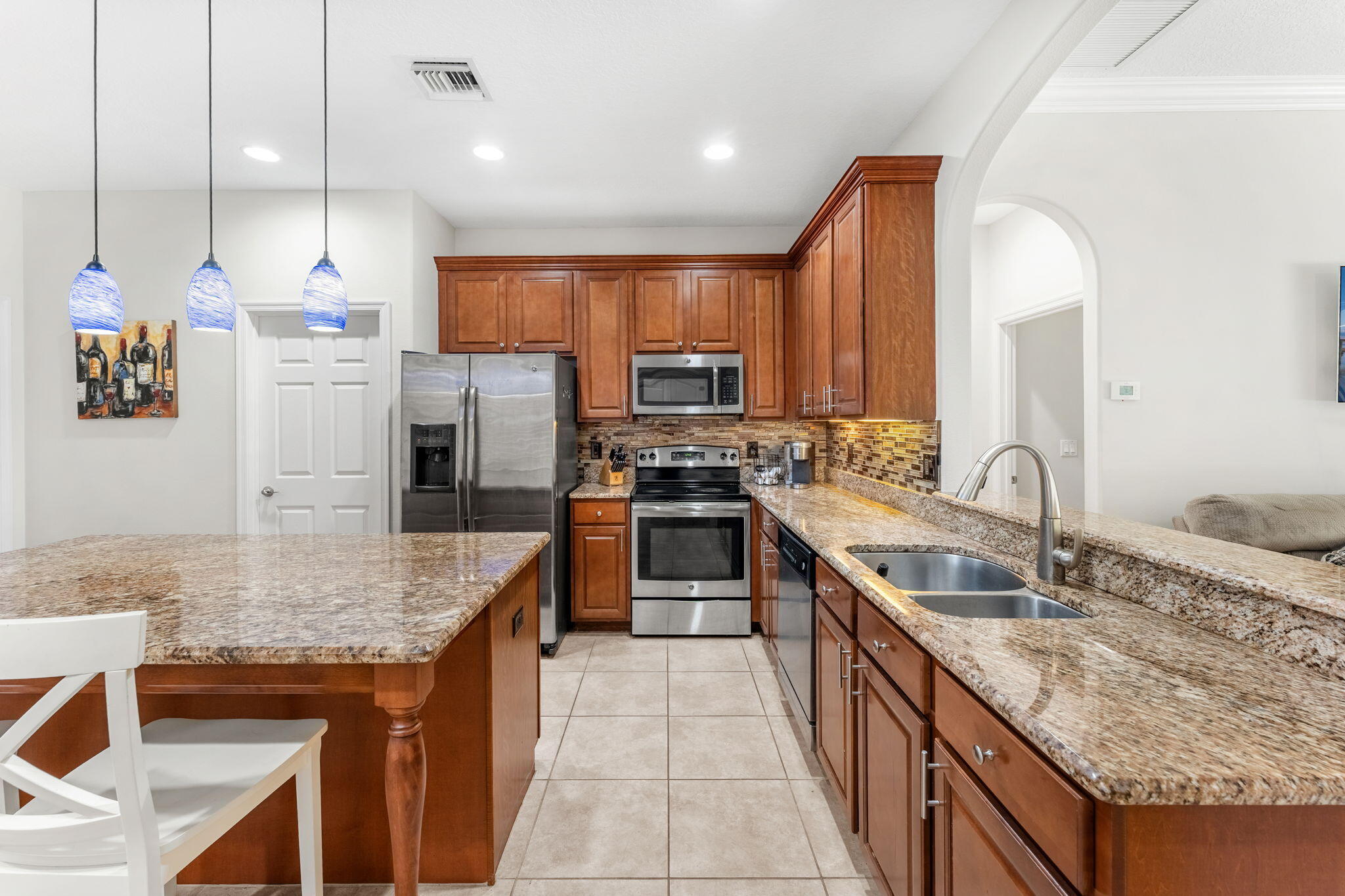 7657 Fieldstone Ranch Square Vero Beach, FL 32967 - Photo 23 of 52 a kitchen with stainless steel appliances granite countertop a sink stove and refrigerator