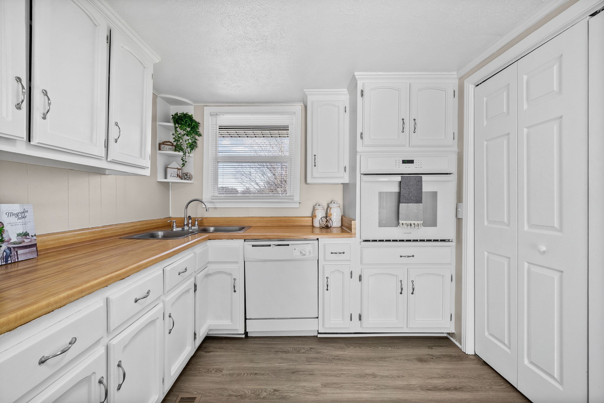 212 Jackson Road Clarksville, TN 37042 - Photo 13 of 32 a kitchen with white cabinets and a window