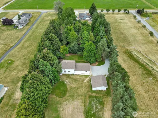 an aerial view of a house with a yard