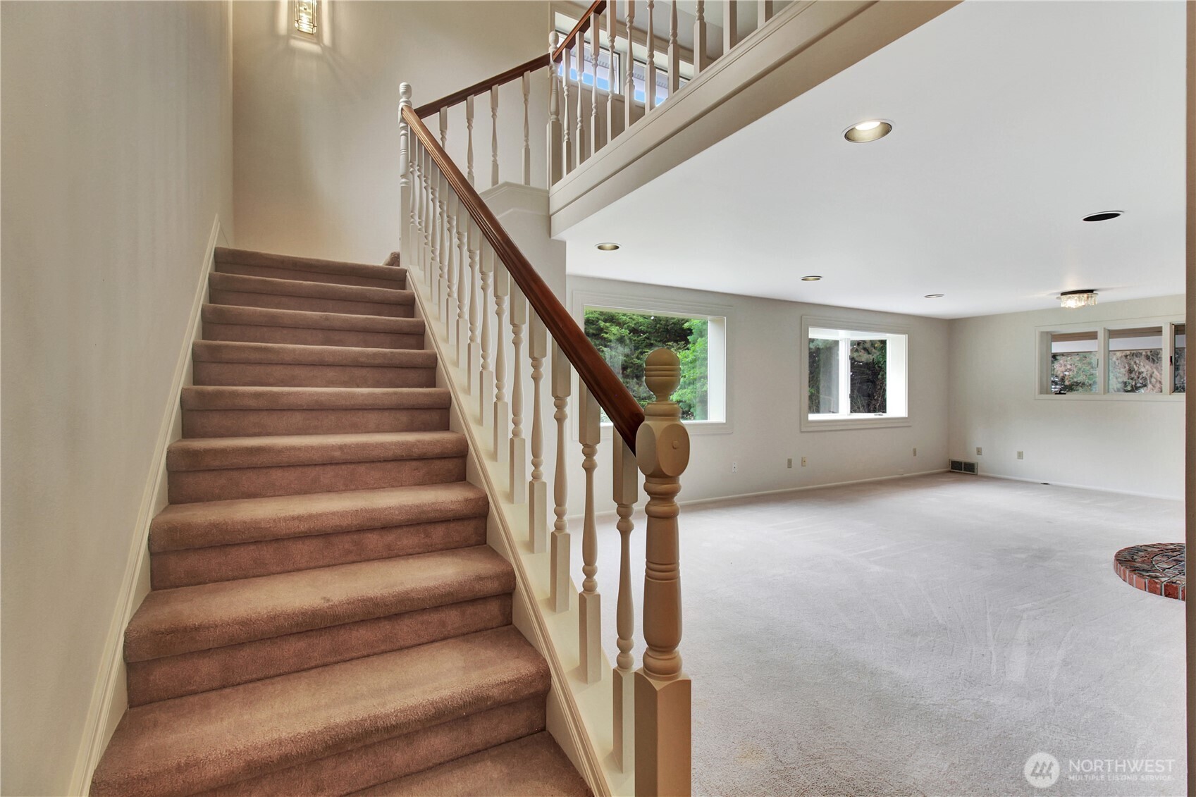 963 Utsalady Road Camano Island, WA 98282 - Photo 17 of 40 a view of staircase with lots of frames on wall and a window