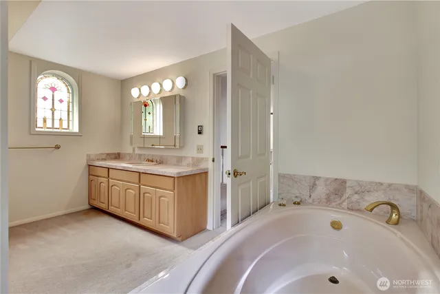 a bathroom with a sink a vanity and a mirror