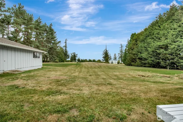 a view of a white house with a yard