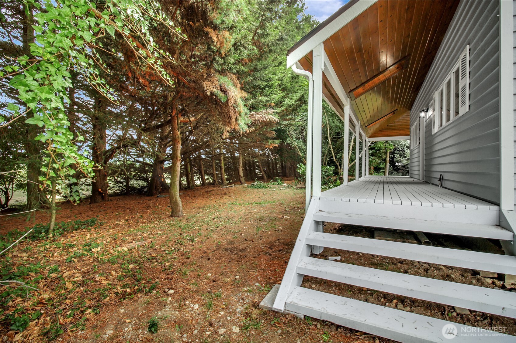 963 Utsalady Road Camano Island, WA 98282 - Photo 32 of 40 a view of a white house with a yard