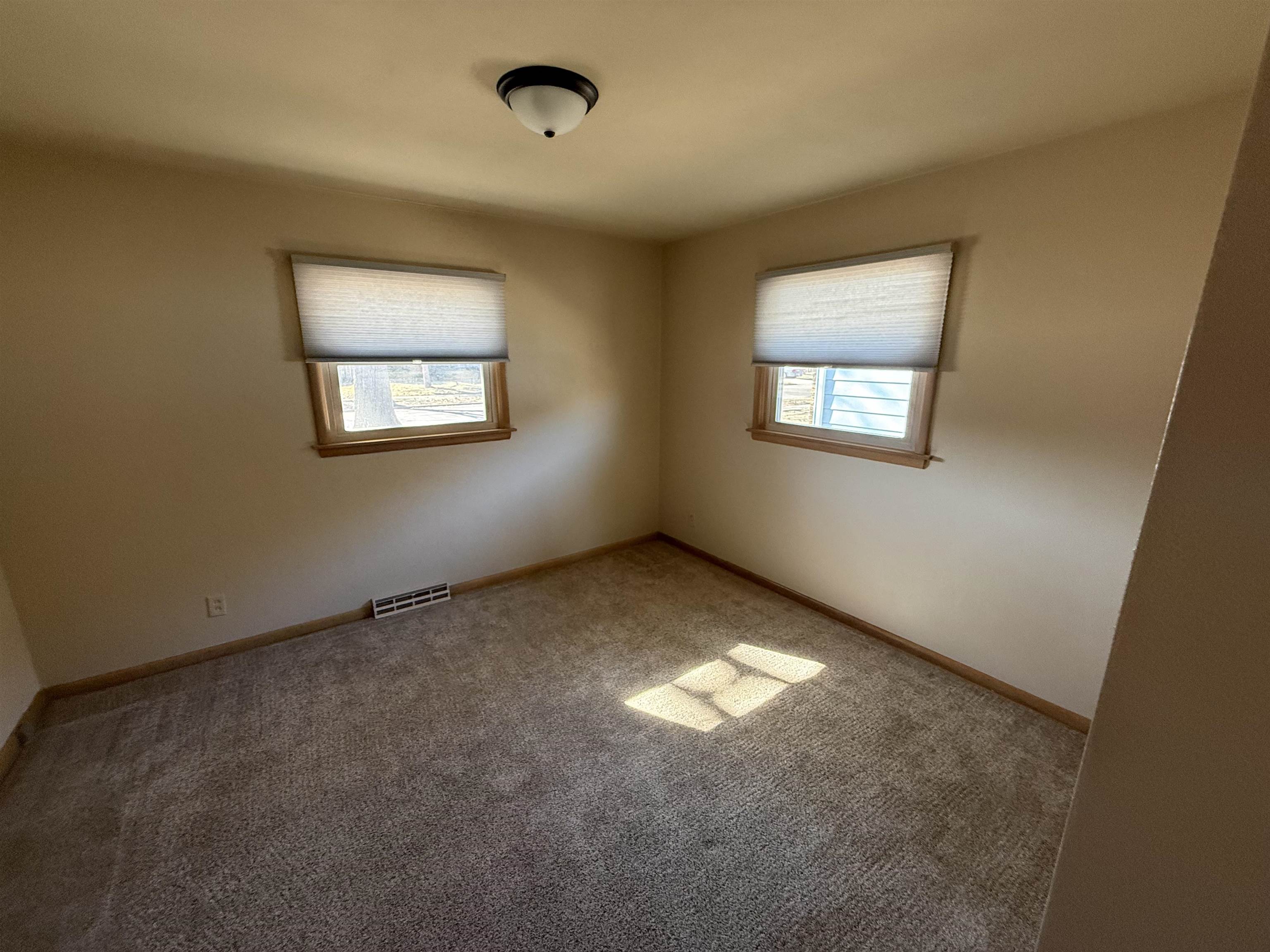 4524 Newcastle Road Rockford, IL 61108 - Photo 11 of 24 an empty room with windows