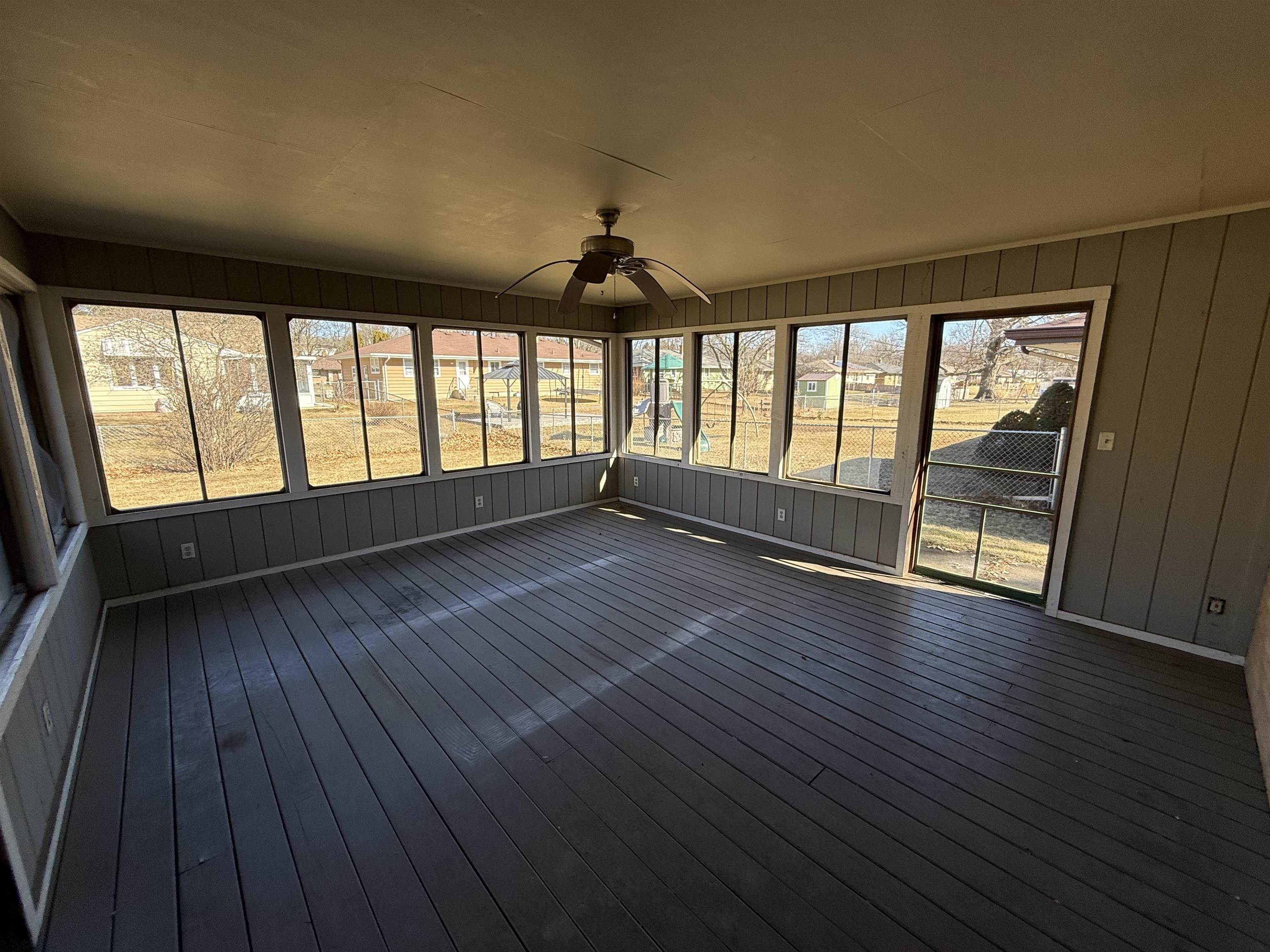 4524 Newcastle Road Rockford, IL 61108 - Photo 20 of 24 an empty room with wooden floor and windows
