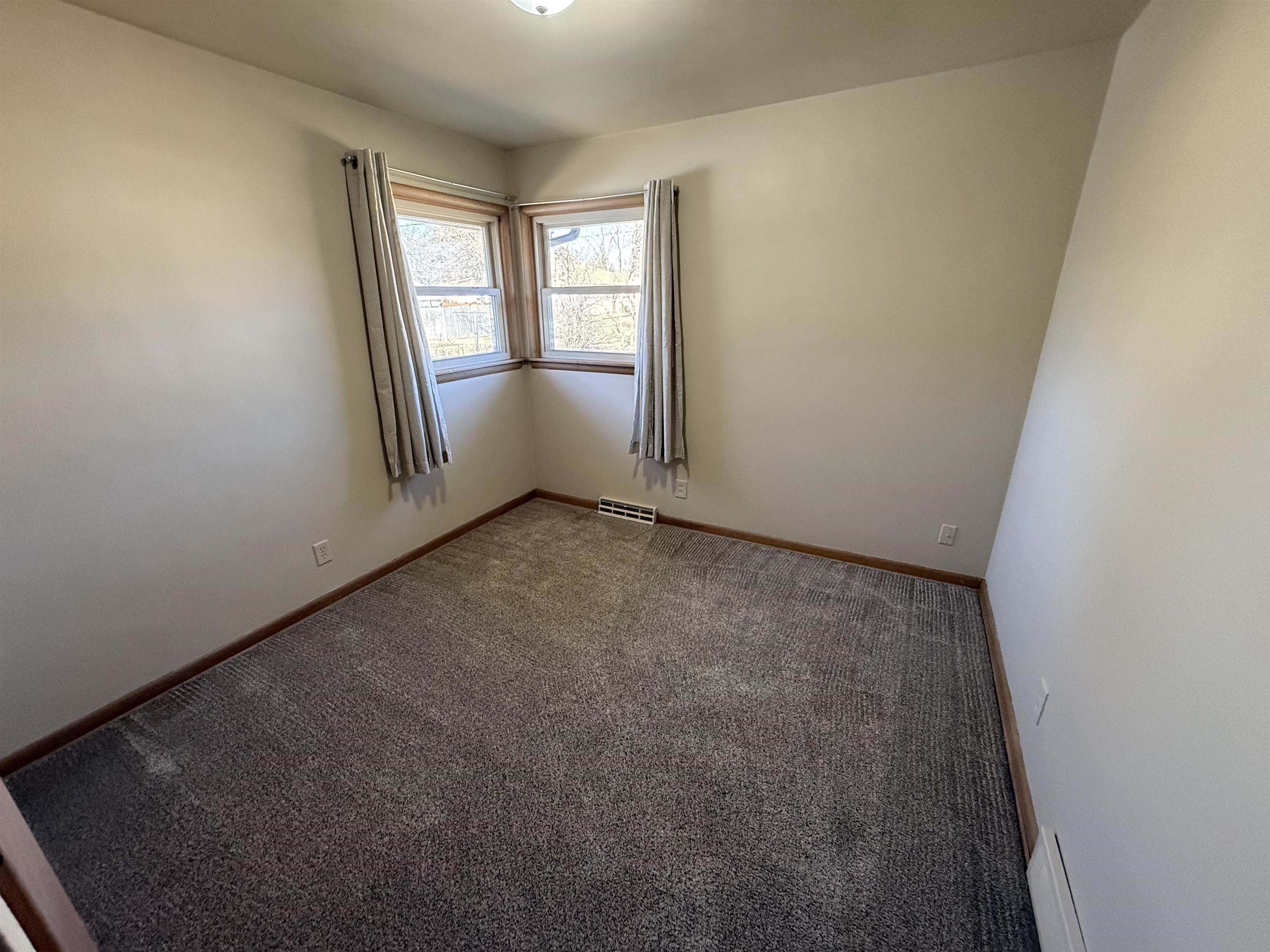 4524 Newcastle Road Rockford, IL 61108 - Photo 8 of 24 an empty room with windows