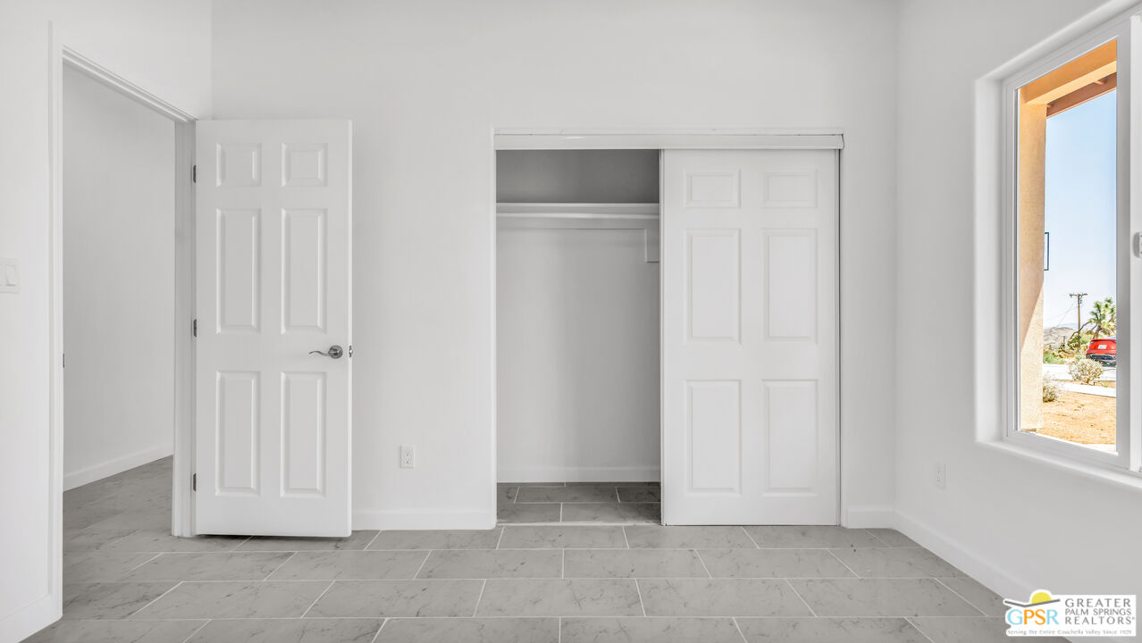7160 Olympic Road Joshua Tree, CA 92252 - Photo 29 of 58 a view of an empty room with windows