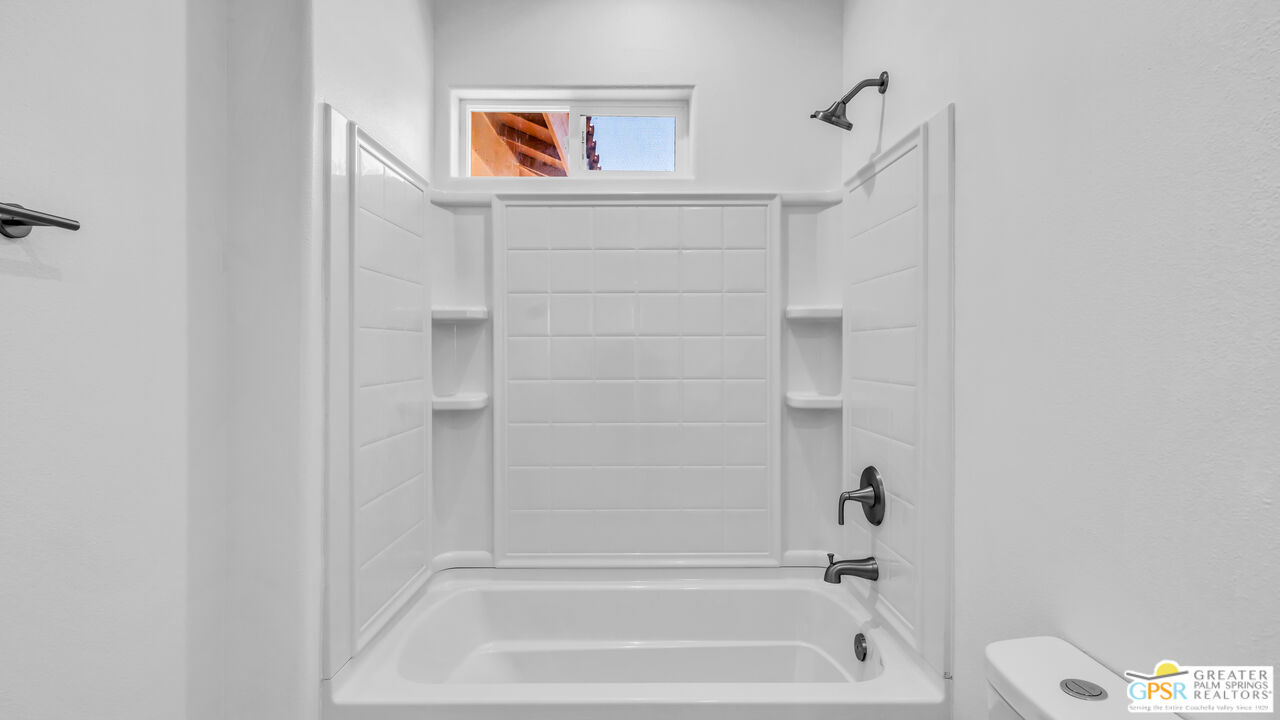 7160 Olympic Road Joshua Tree, CA 92252 - Photo 30 of 58 a bathroom with a bathtub and a shower
