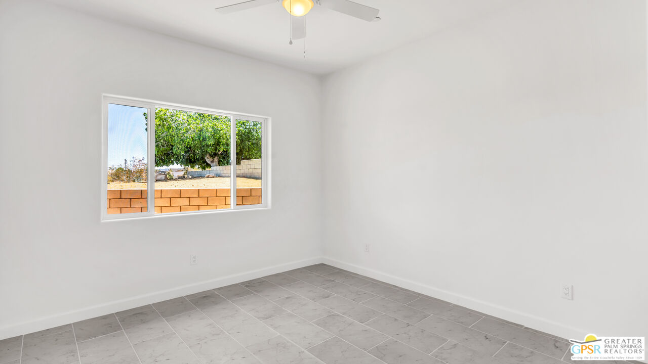 7160 Olympic Road Joshua Tree, CA 92252 - Photo 32 of 58 an empty room with a window