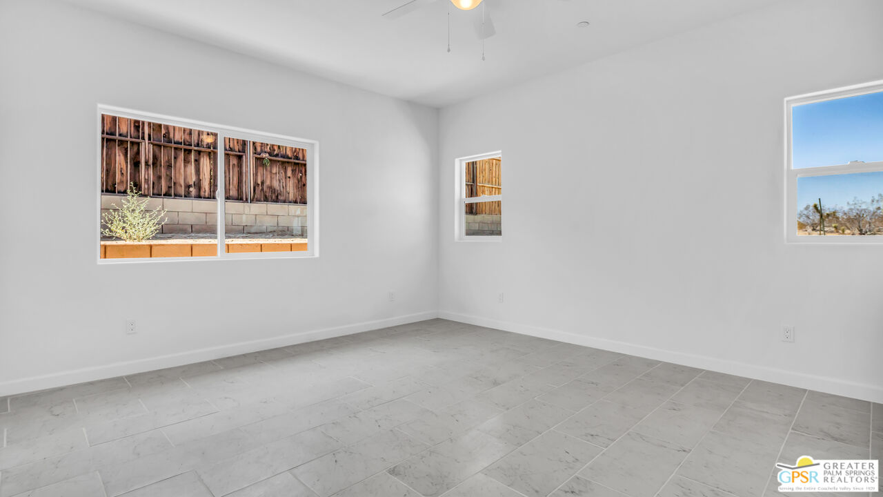 7160 Olympic Road Joshua Tree, CA 92252 - Photo 34 of 58 an empty room with windows