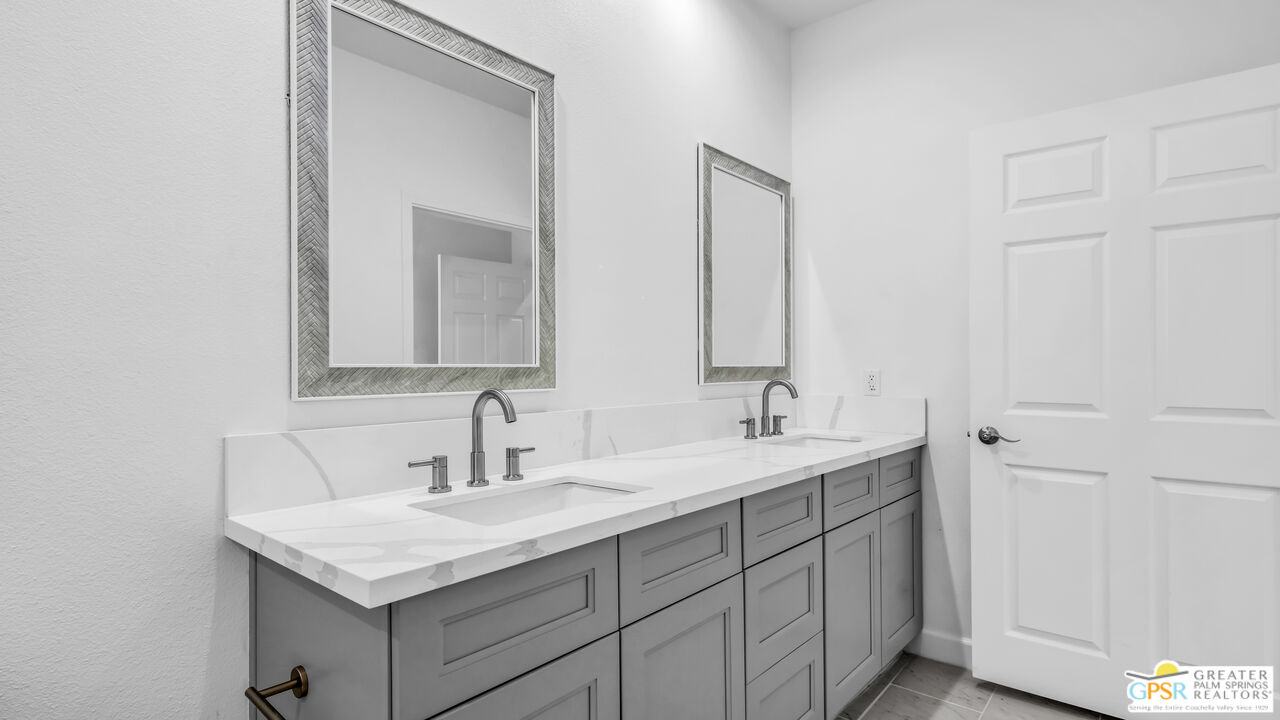7160 Olympic Road Joshua Tree, CA 92252 - Photo 39 of 58 a bathroom with 2 sink and a mirror