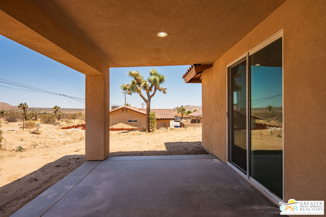 7160 Olympic Road Joshua Tree, CA 92252 - Photo 42 of 58 a view of a living room and a flat screen tv