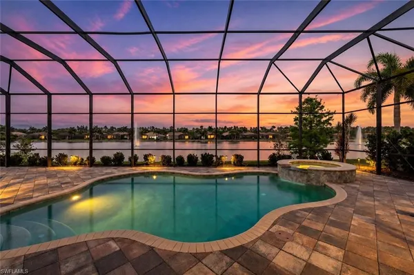 a swimming pool with outdoor seating yard and barbeque oven