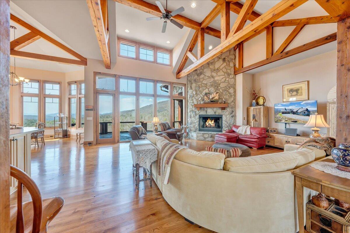 144 Seven Ridges Road Hot Springs, VA 24445 - Photo 13 of 89 a living room with fireplace furniture and a wooden floor